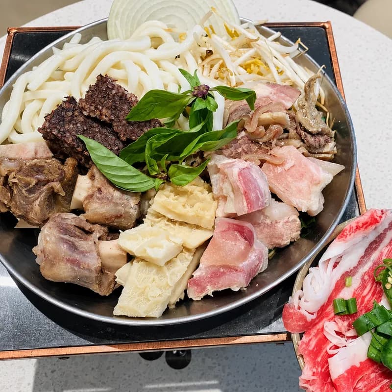 Bún bò Huế ingredients with beef shank, oxtail and thick rice noodles