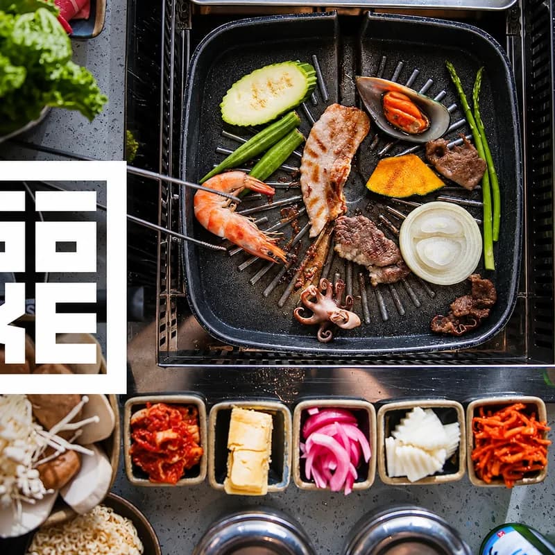 Sōke's logo beside an overhead photo of the tabletop grill with seafood, meats, vegetables and side dishes