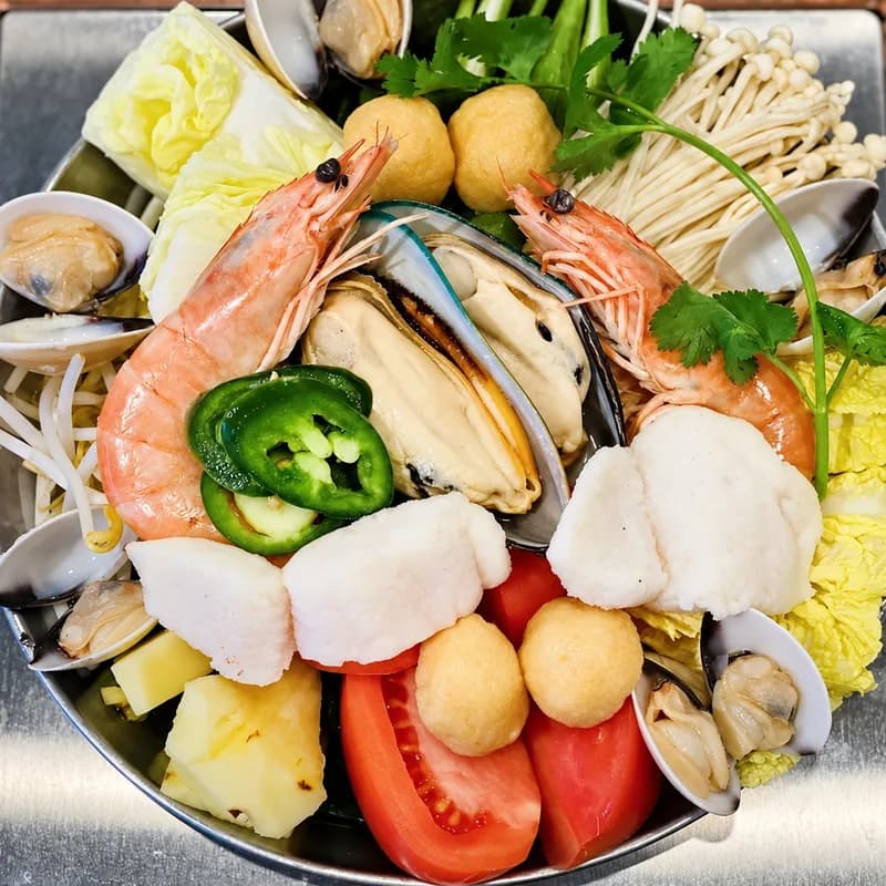 Thai tom yum single pot with shrimp, mussels, clams and fish balls