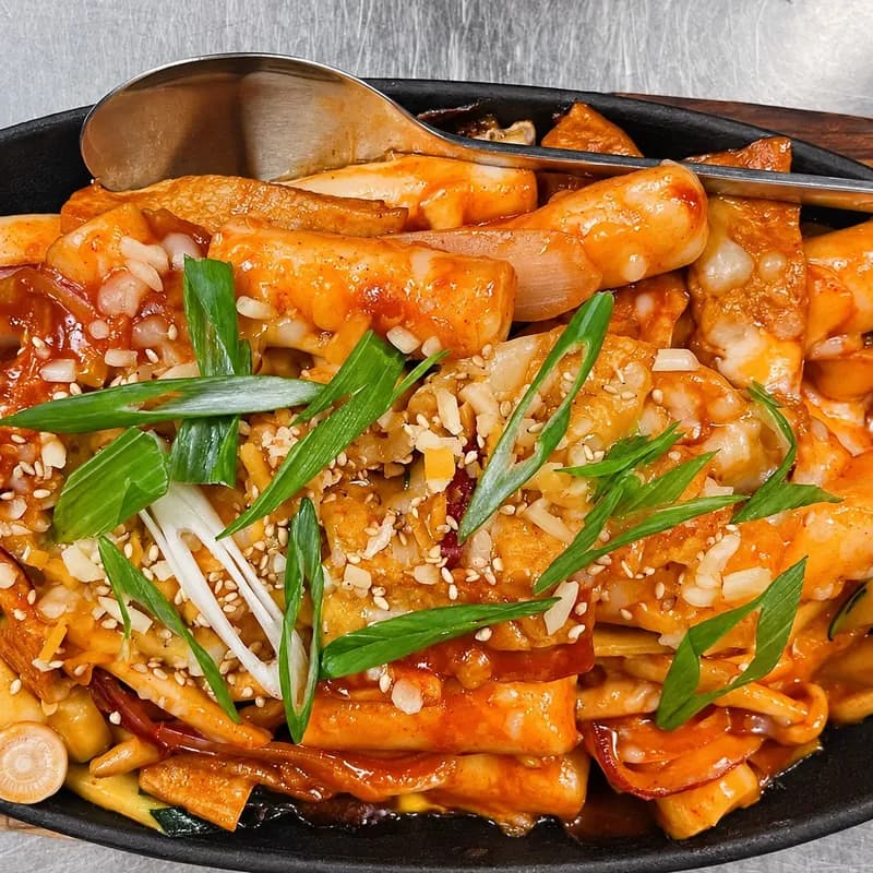 Tteokbokki rice cakes in red chili sauce with green onion